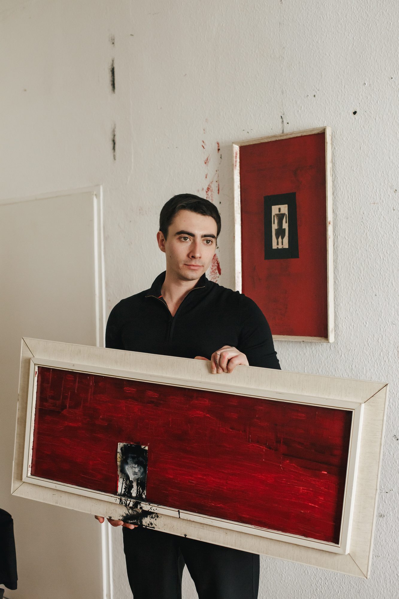 BROK holding a red painting, contemporary artist in Berlin